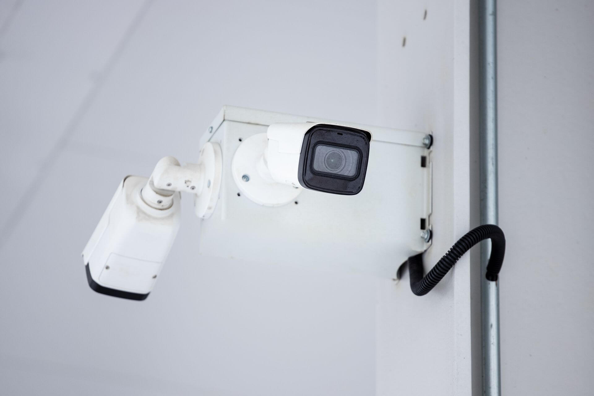 Technician installing and configuring a commercial surveillance camera system for facility access control in Ohio.